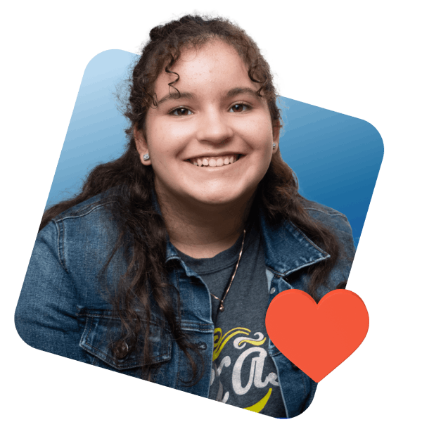 A girl smiling brightly, with a heart symbol prominently displayed in the center of her face.